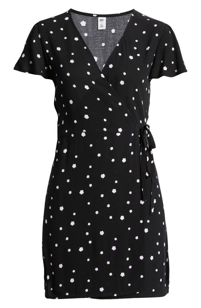 The black wrap dress with white little flower dots on it