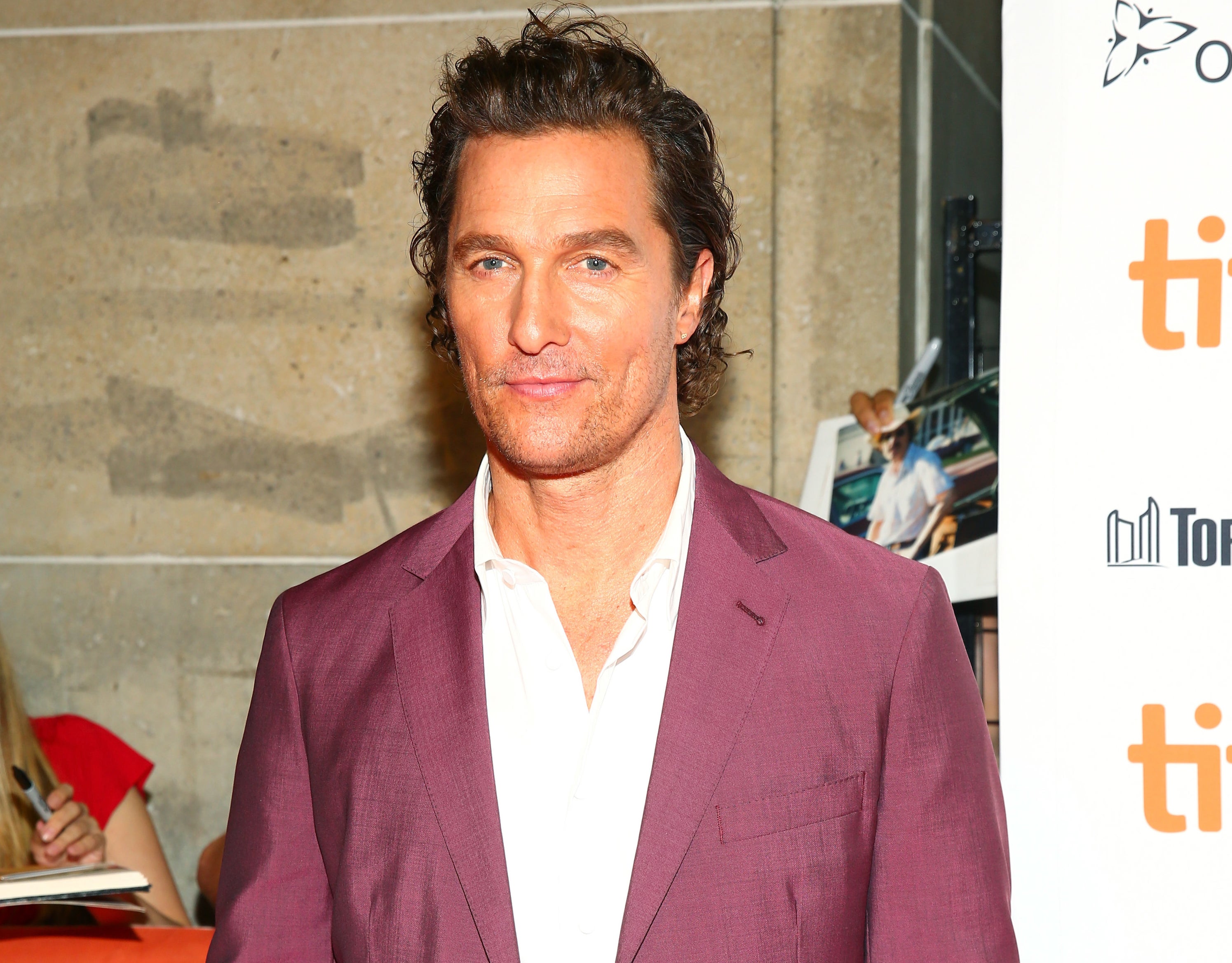 Matthew wears a maroon suit jacket to a film festival