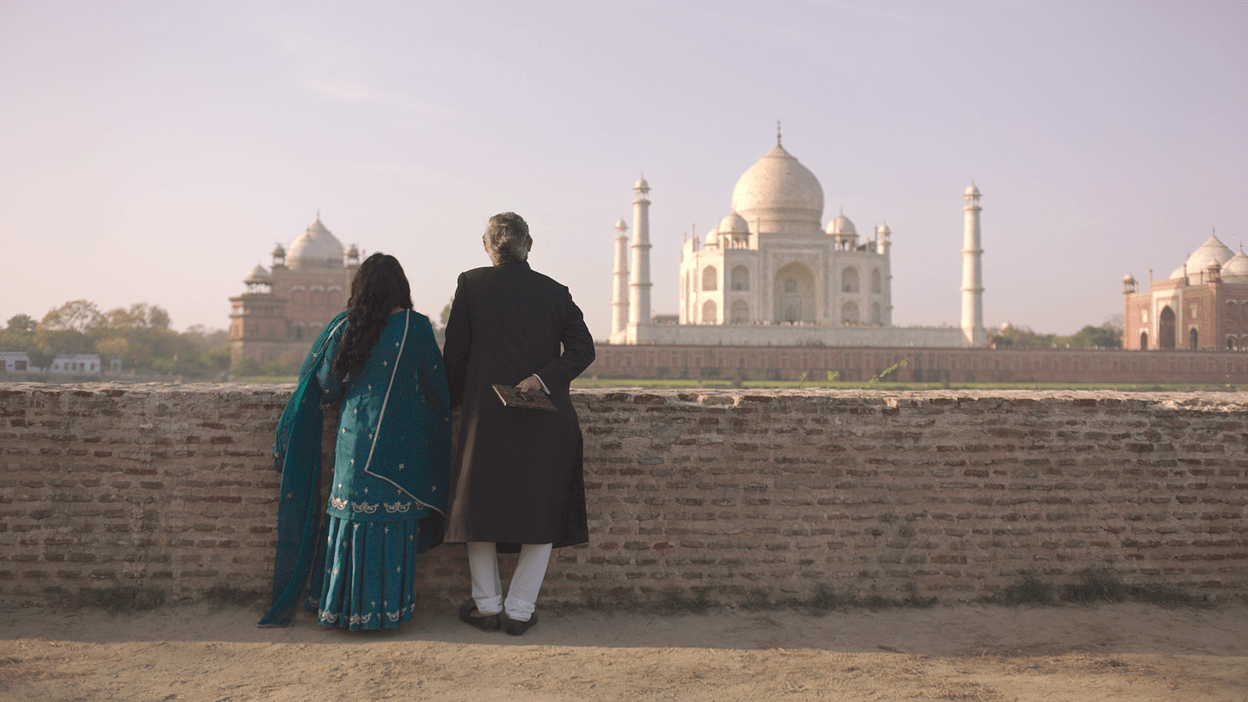 a couple from the show looking at the taj mahal 