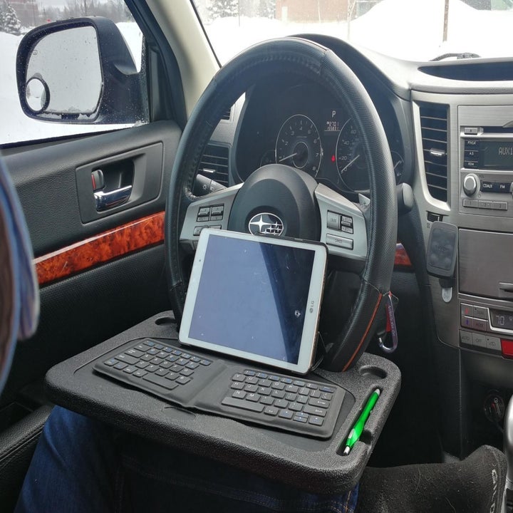 same reviewer's photo showing tablet and keyboard on laptop tray 