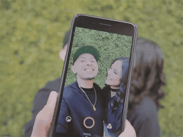P-Lo taking a selfie with a woman