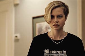 Siobhan with short hair shaved on one side, wearing a t-shirt, looking concerned