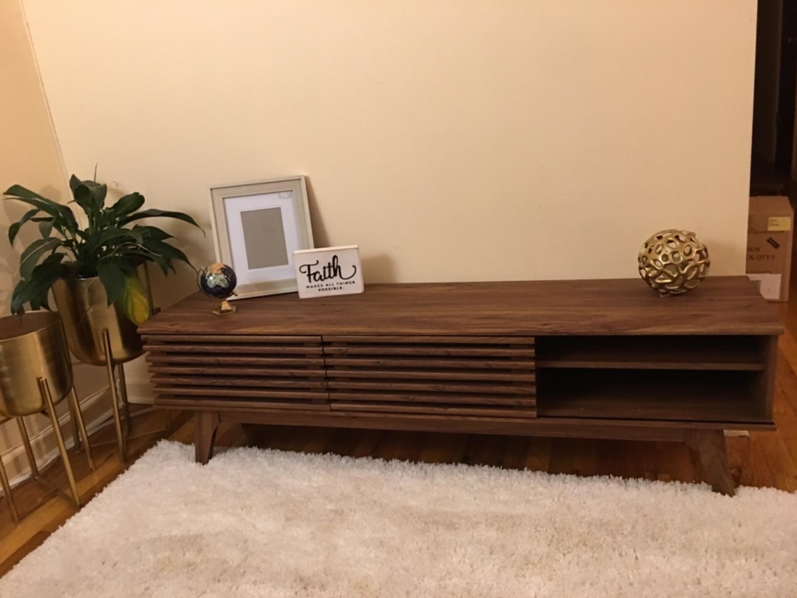 A reviewer photo of the TV stand in brown