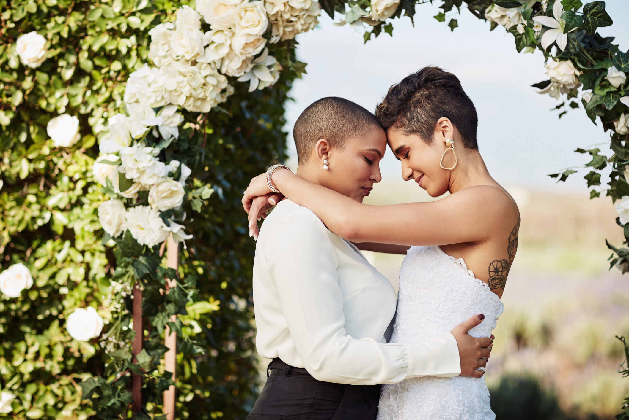 Two woman on their wedding day dancing 