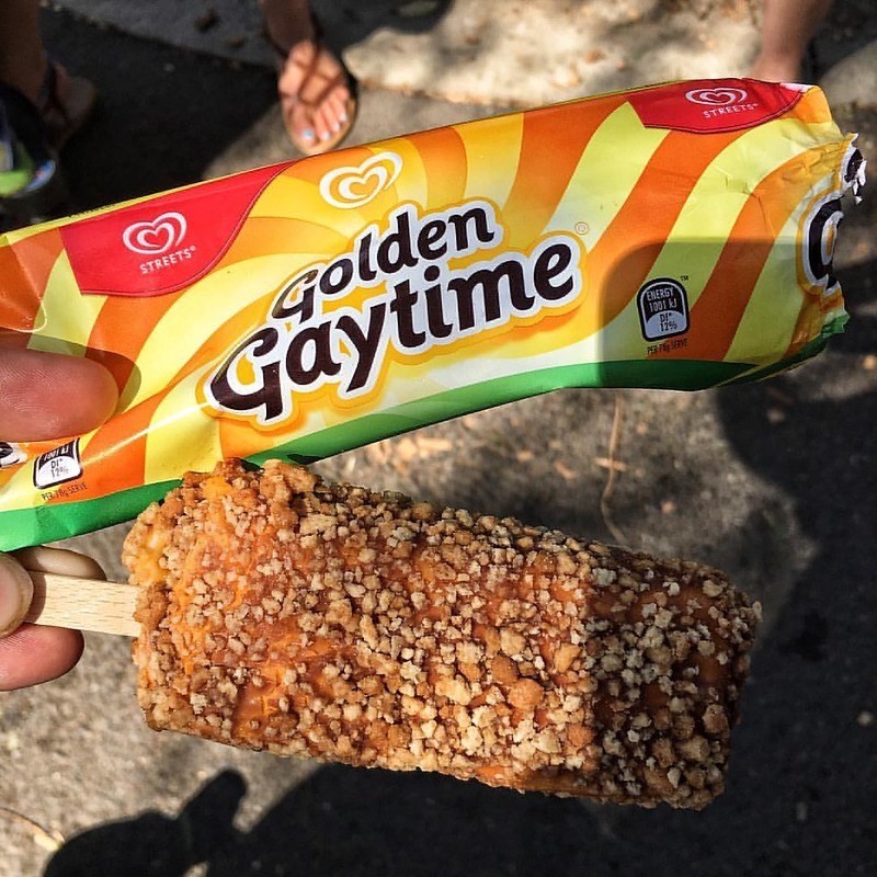 Hand holding a Golden Gaytime ice cream and it&#x27;s packaging.