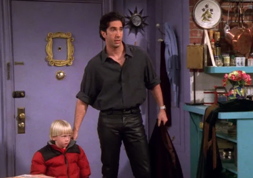Ross strikes a pose in his new leather pants while usher his son, Ben, into Monica&#x27;s apartment. 