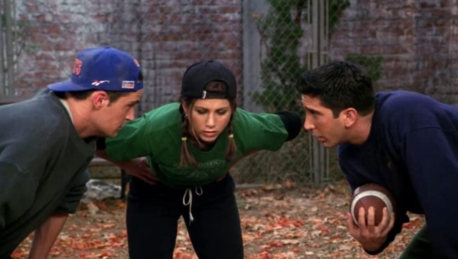 Chandler, Rachel, and Ross huddle together to go over their football game plan.