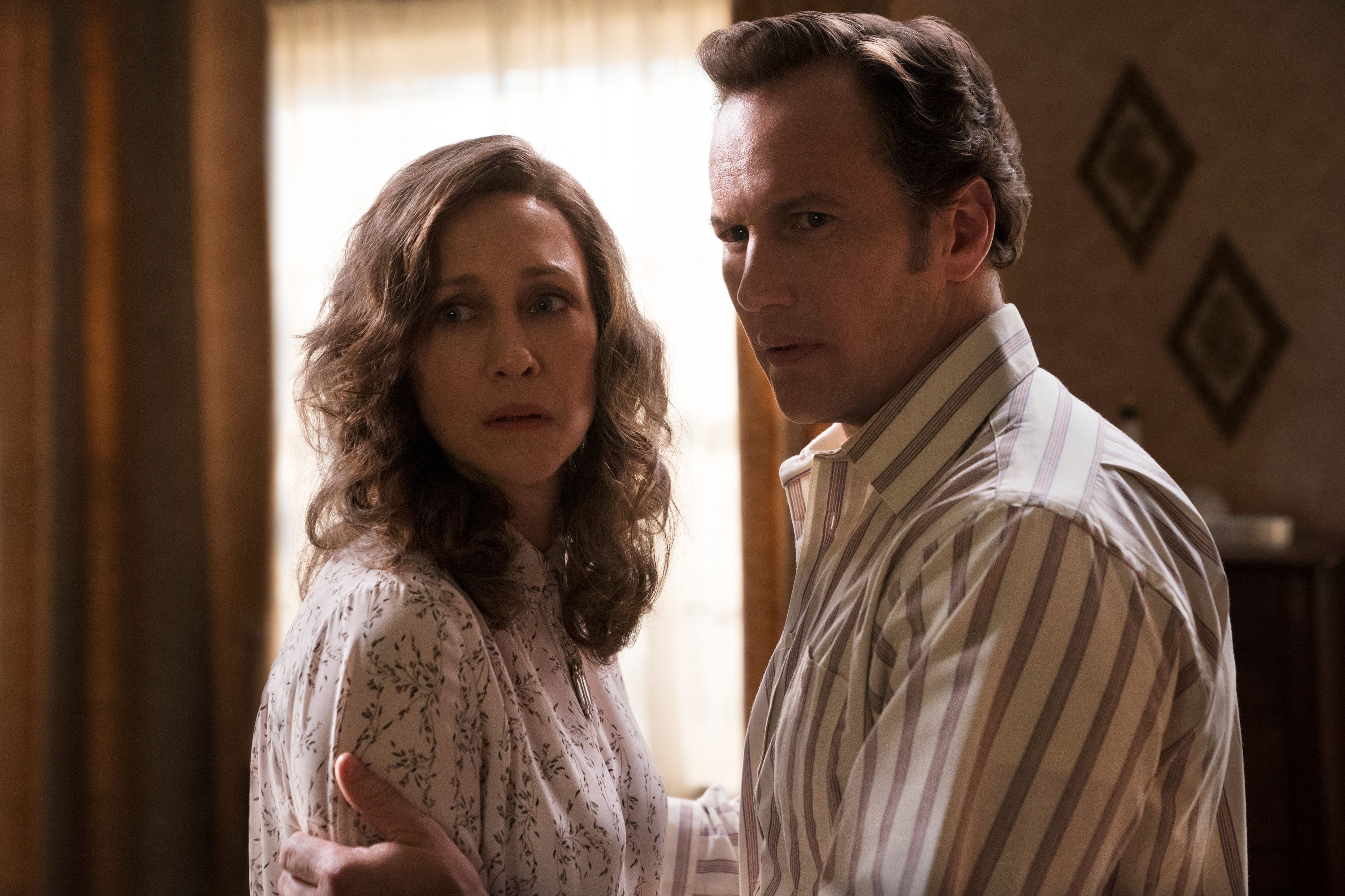 Vera Farmiga and Patrick Wilson as Lorraine and Ed Warren appearing to look scared and concerned