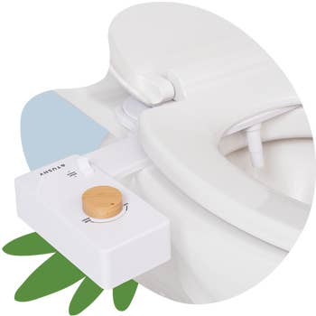 the white bidet with wood knob on a toilet, installed under the seat