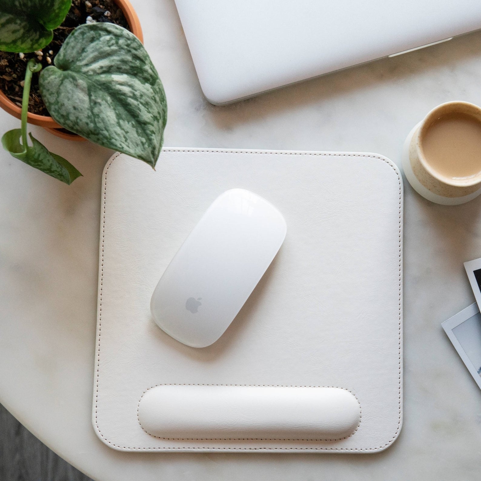 product image of white mousepad with wrist rest with Apple mouse on it