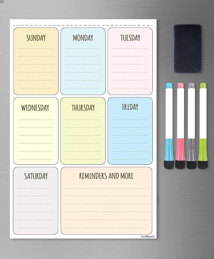 Colourful dry erase daily planner on fridge door with four colourful markers