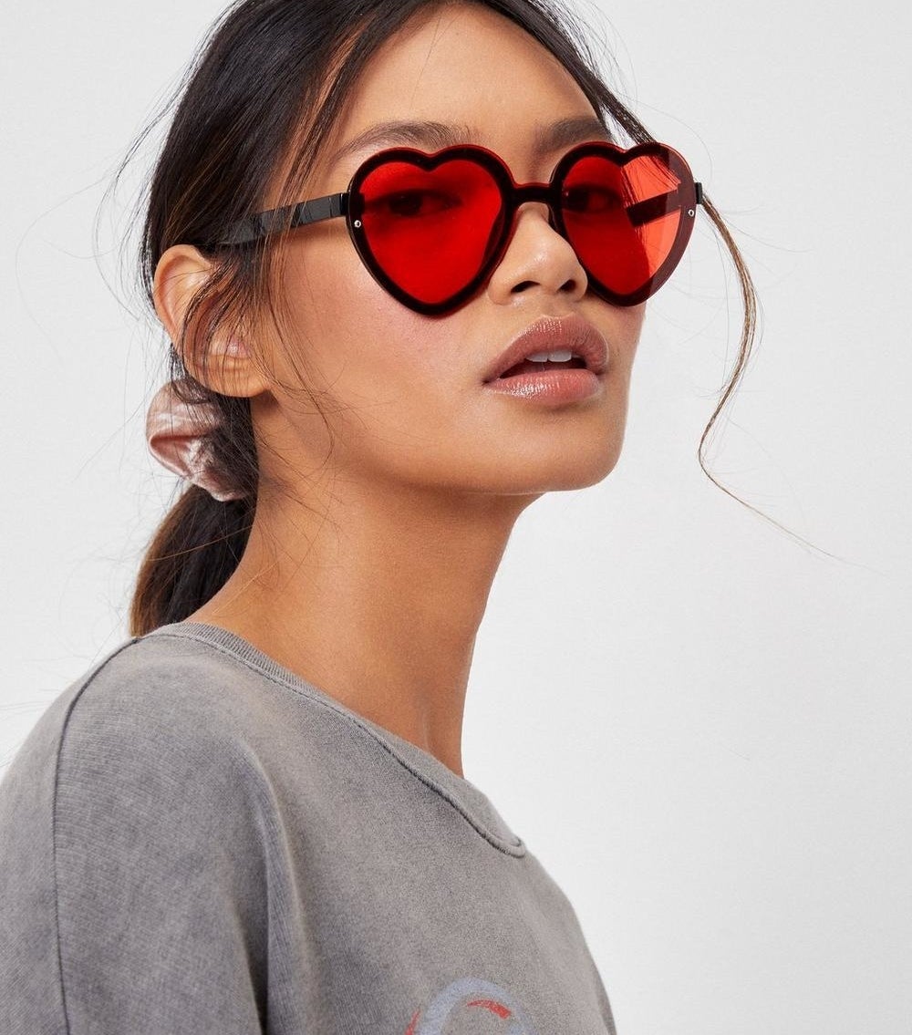 a person wearing heart-shaped sun glasses 