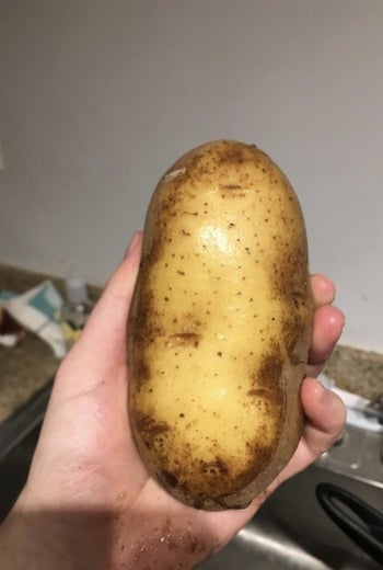a visibly cleaned potato after scrubbing