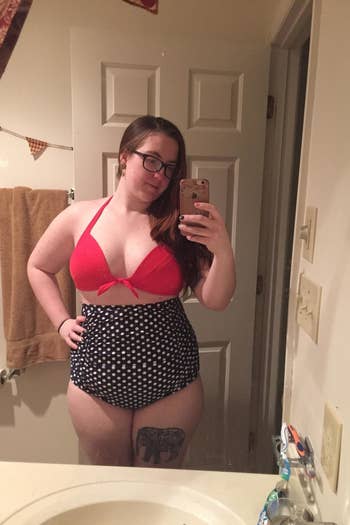 reviewer wearing the version with a red top and navy polka dot bottoms
