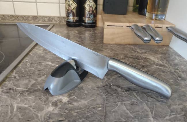 a kitchen knife resting on a knife sharpener