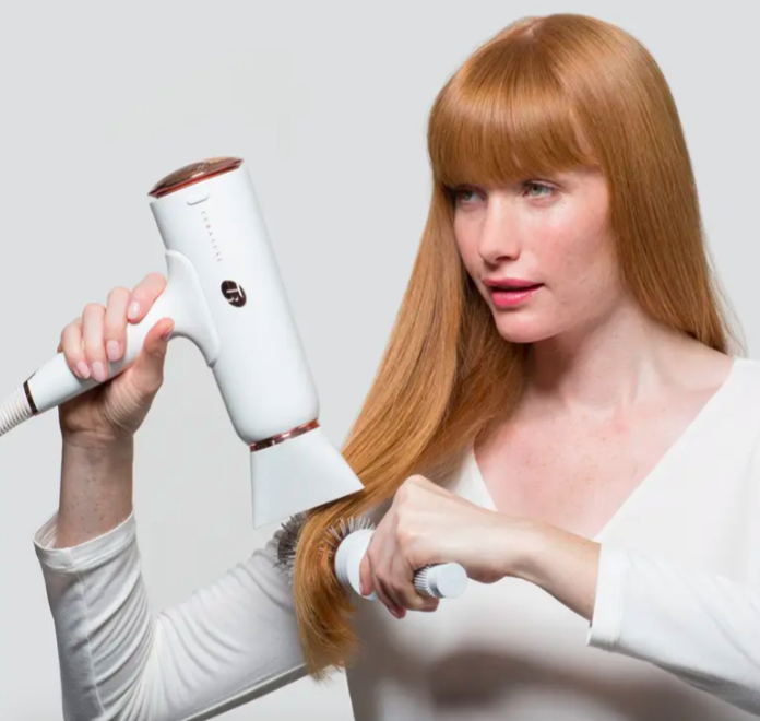 A model blow-drying her hair with the T3 Cura Luxe Professional Ionic hair dryer