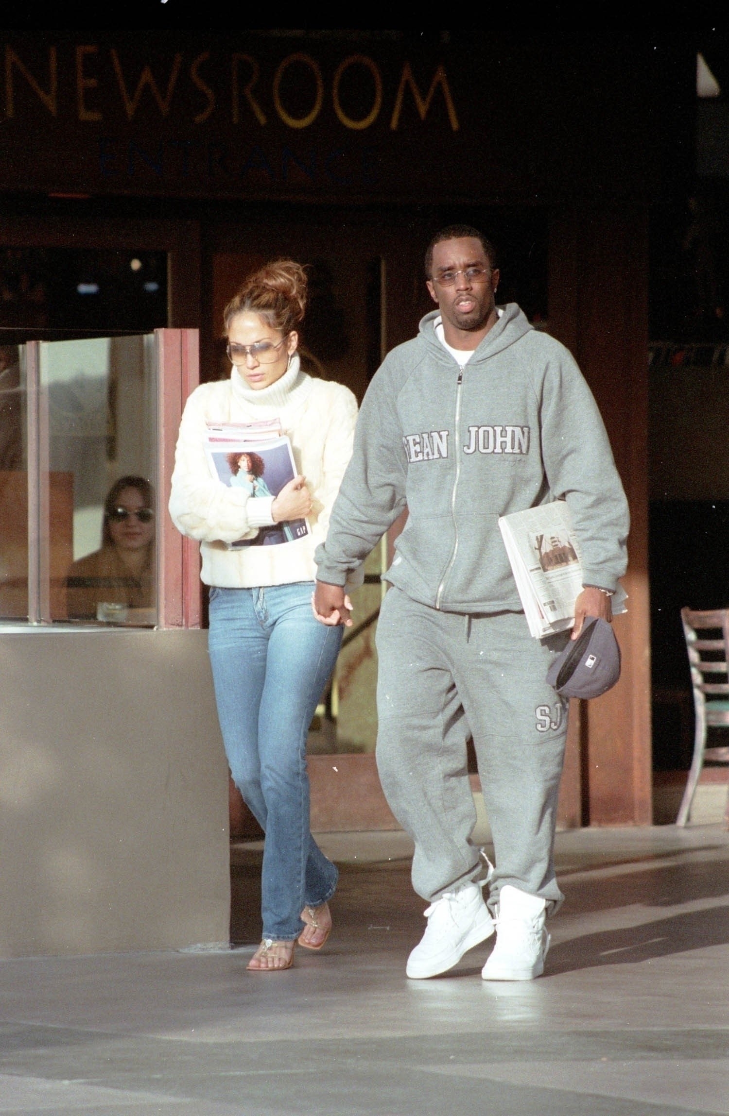 JLo and Diddy holding hands as they walk outside