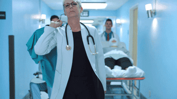 A doctor walking with sass down a hall