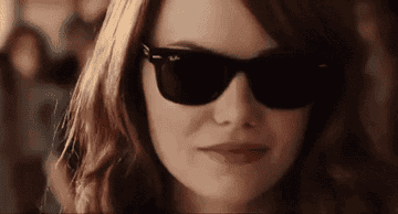 Emma Stone walking with sunglasses on in Easy A