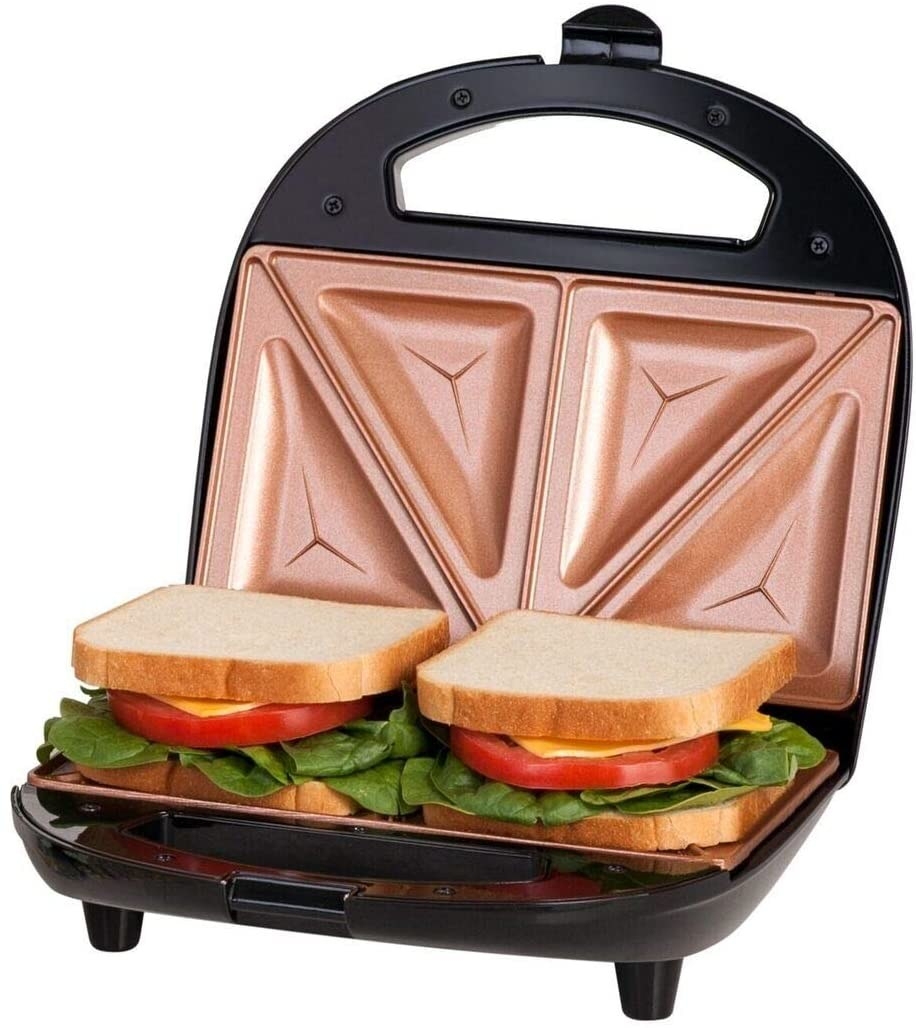 the sandwich maker with two sandwiches in ti and the lid propped up