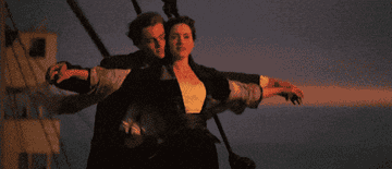 Rose and Jack putting their arms out on the deck of the Titanic in Titanic