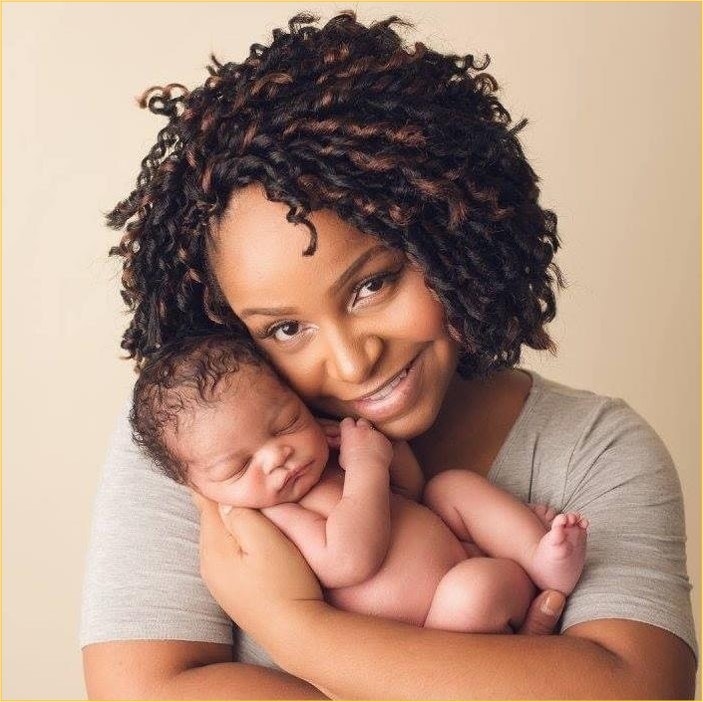 A woman cradles her newborn baby boy