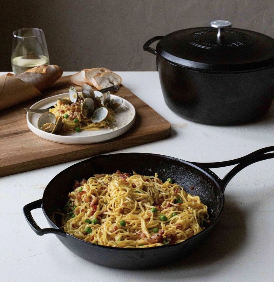 A cast-iron skillet with noodles inside