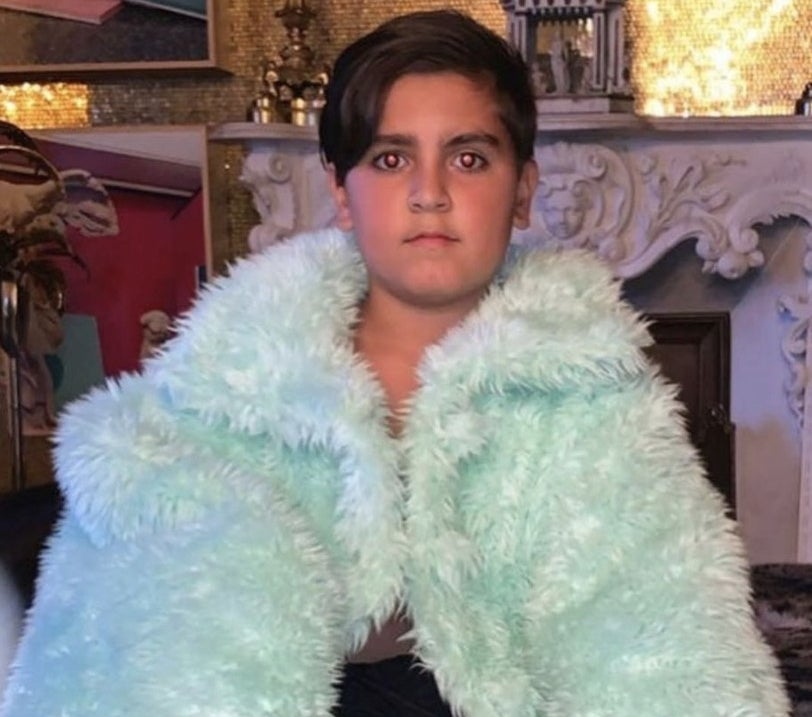 A photo of Mason with a fuzzy blue blanket around his shoulders