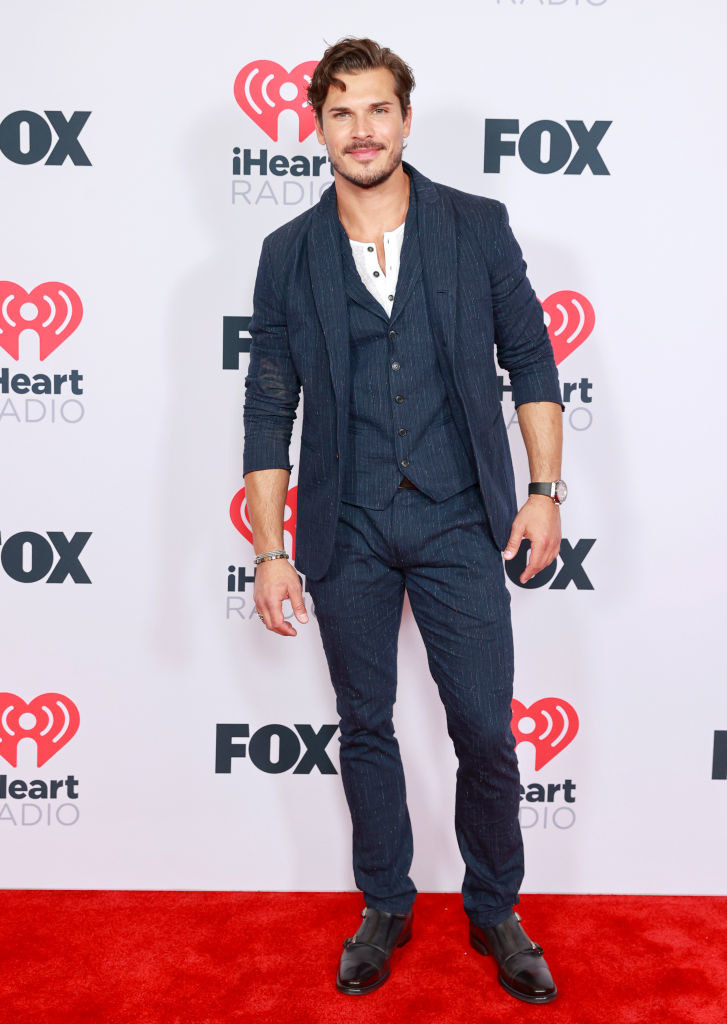 Gleb Savchenko wore a pinstripe suit the 2021 iHeartRadio Music Awards