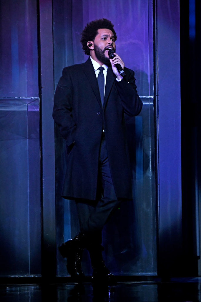 The Weeknd performs onstage at the 2021 iHeartRadio Music Awards in a suit