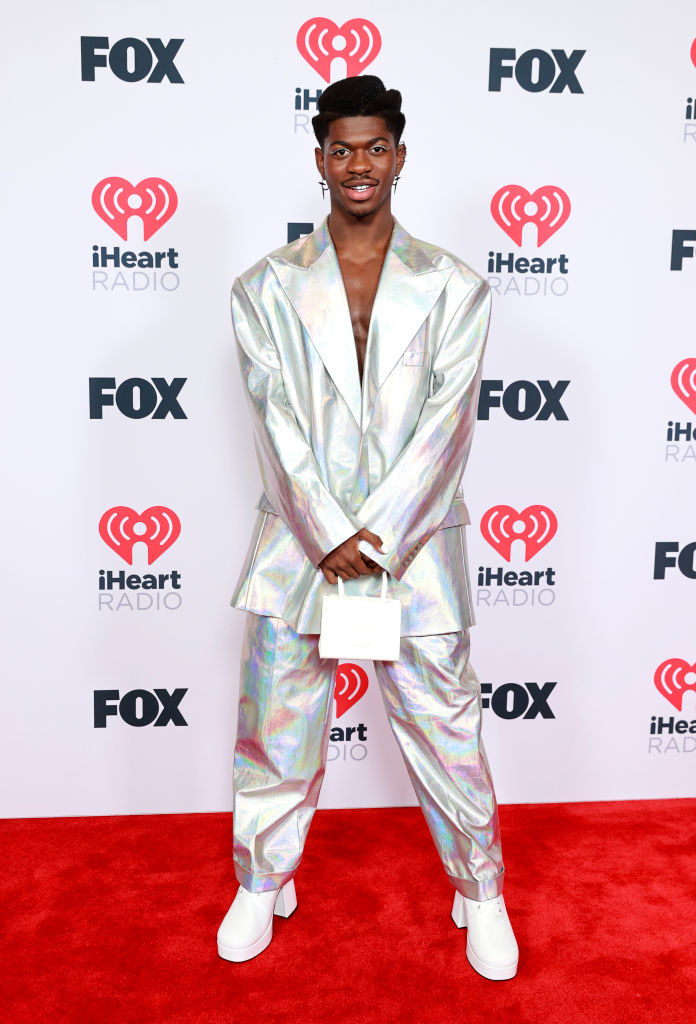 Lil Nas X attends the 2021 iHeartRadio Music Awards in a holographic suit and platform shoes