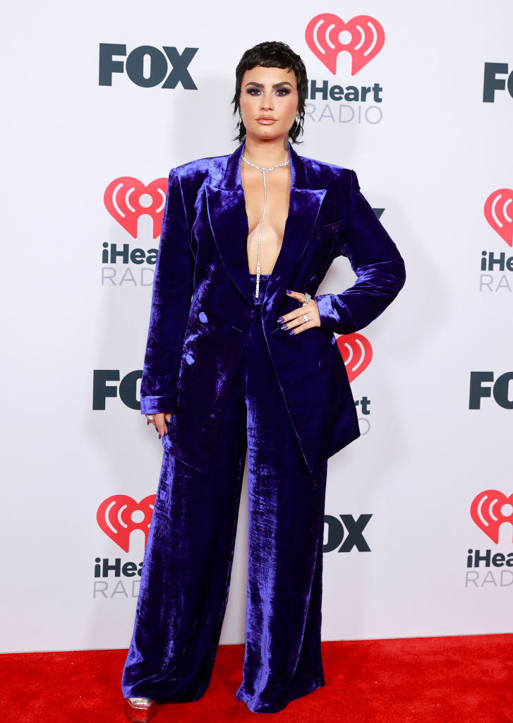 Demi Lovato attends the 2021 iHeartRadio Music Awards in a velour suit