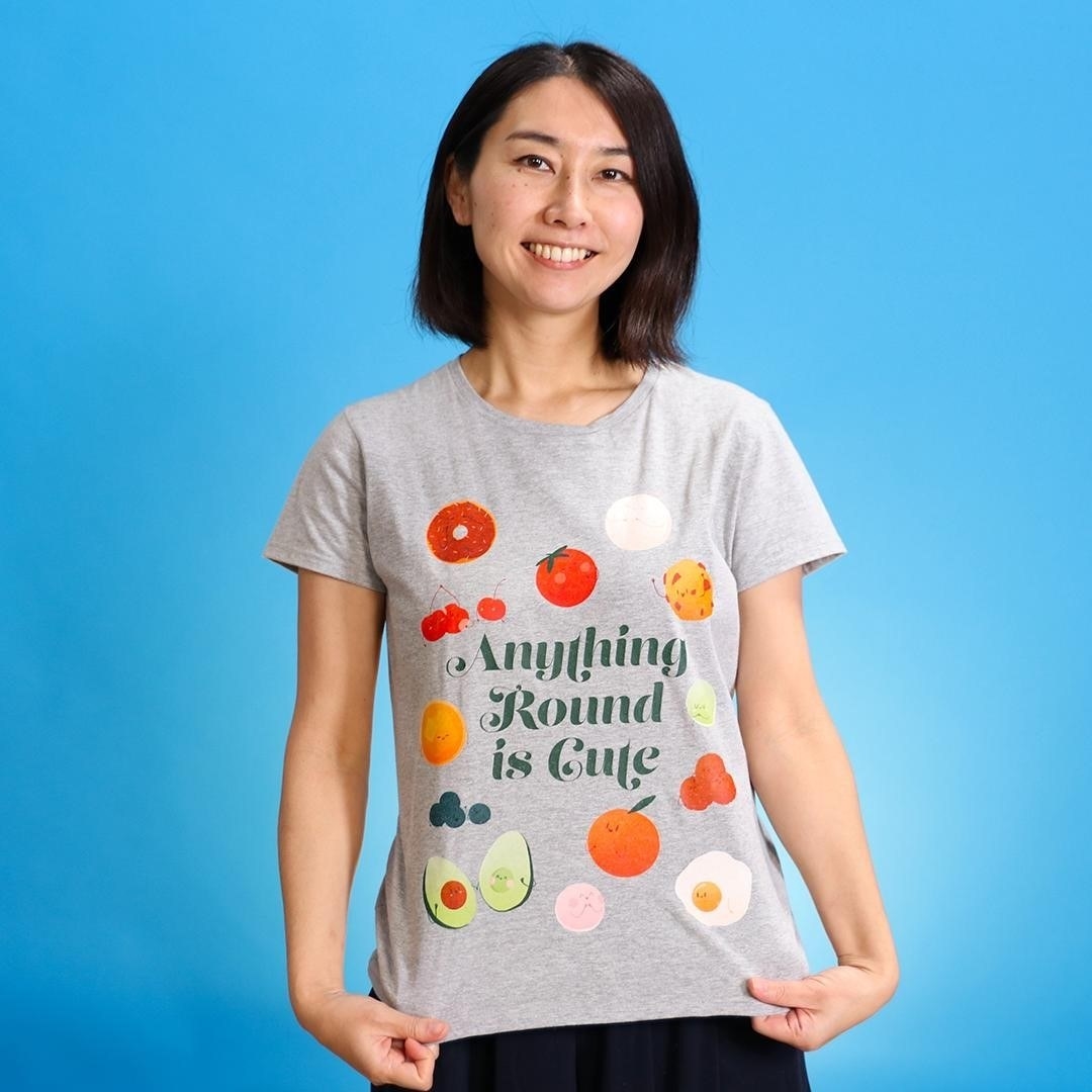 grey t-shirt with illustrations of different food and the phrase "Anything round is cute" on it