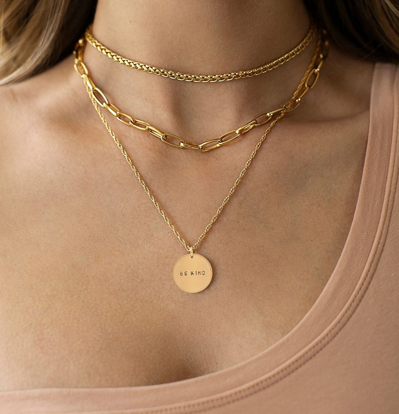model wearing two chain and one pendant necklaces