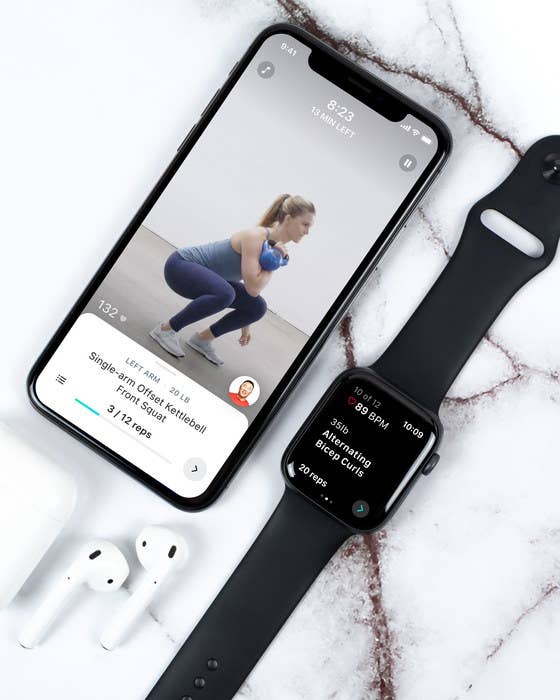 A phone with the Future app open pictured with an Apple Watch and earbuds