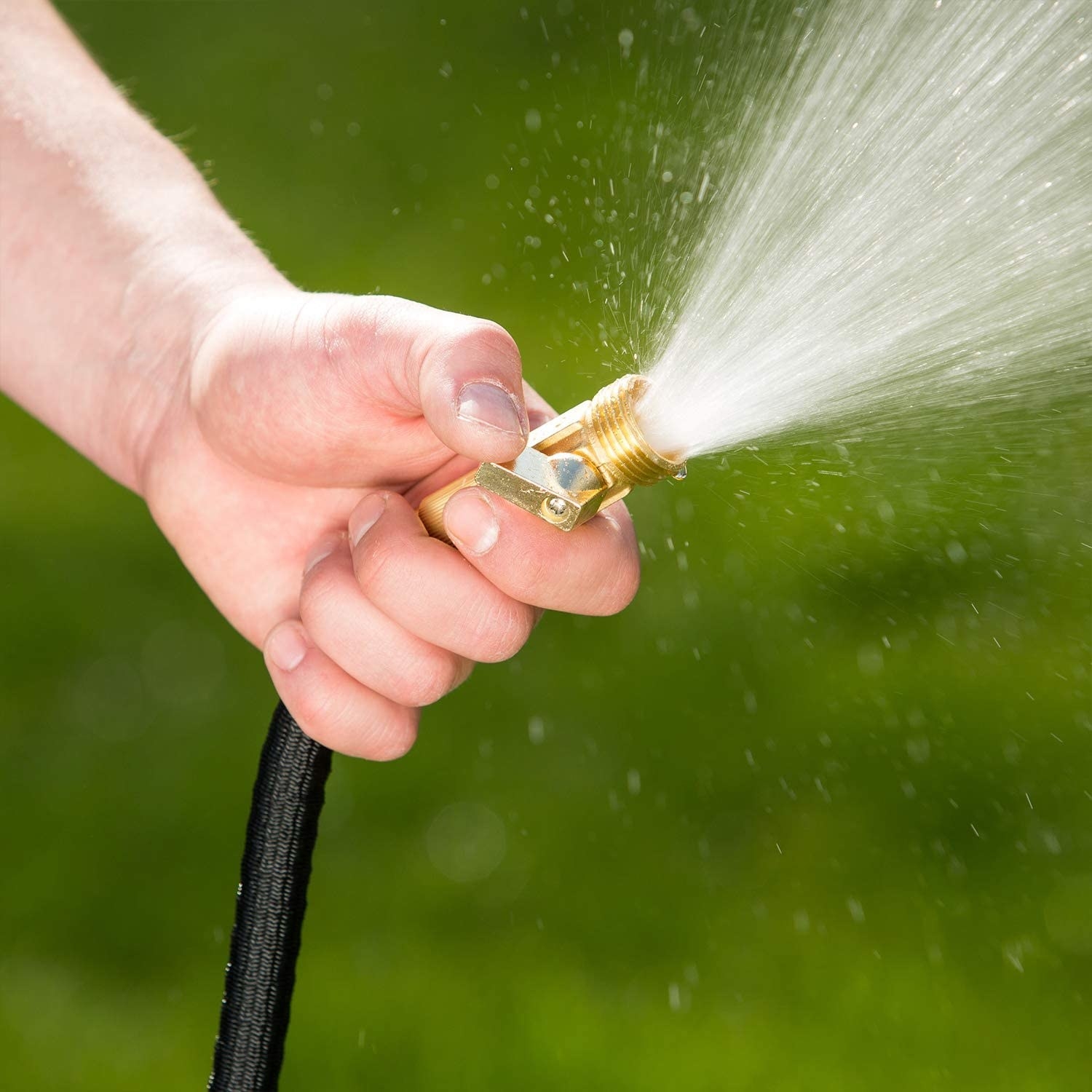 person holding the hose with water coming out of it