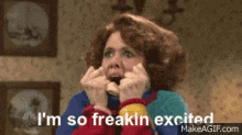gif of Kristin Wiig in the tv show &quot;SNL&quot; with her turtleneck over her mouth saying &quot;I&#x27;m so freakin excited&quot;
