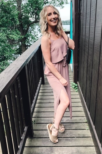 A different reviewer wearing the dress in pale pink