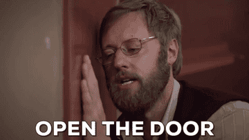 Man pressing his hand into the door and leaning his face against it so his glasses are askew, saying Open the door