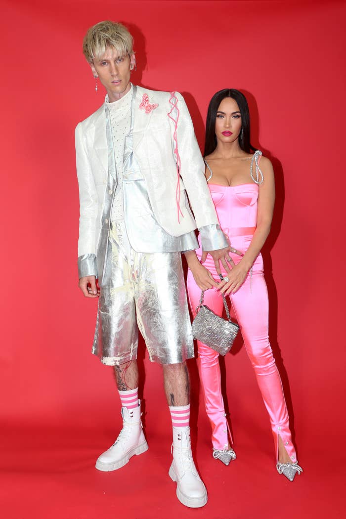 Machine Gun Kelly&#x27;s full outfit features matching metallic shorts, white high tops and pink striped socks