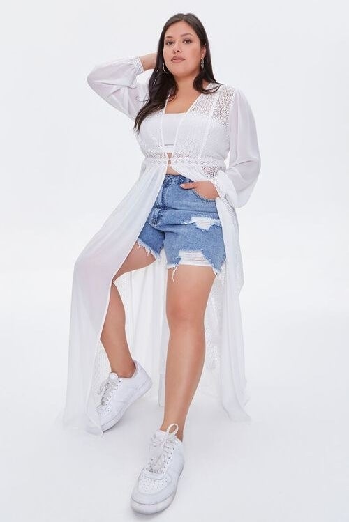 Model wearing long sleeve ,white see-through duster, stops at the knee