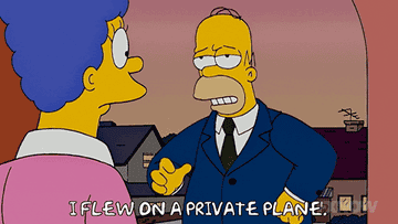 Homer Simpson wearing a suit saying, &quot;I flew on a private plane&quot;