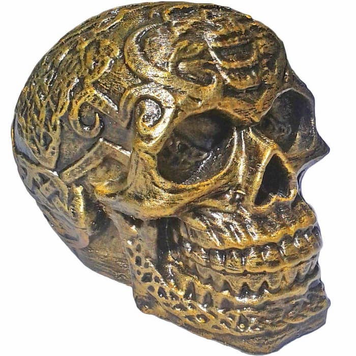 A golden patterned skull showpiece.