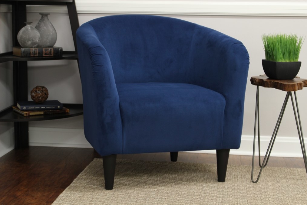 a dark blue rounded accent chair