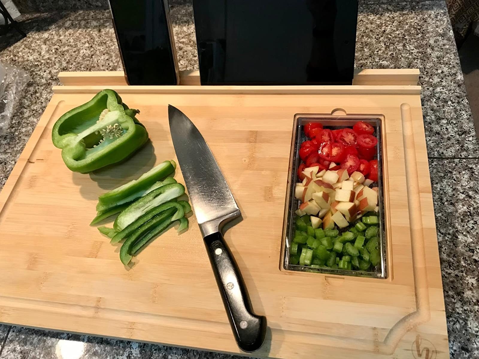 The cutting board with a tablet holder and space for a prep dish