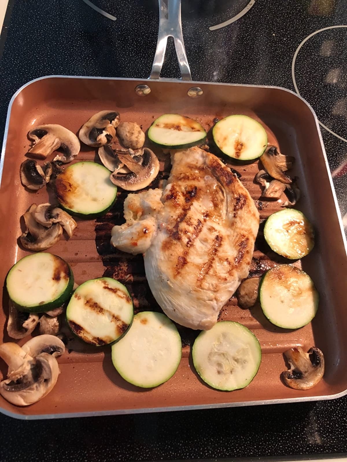 The square pan cooking chicken and vegetables