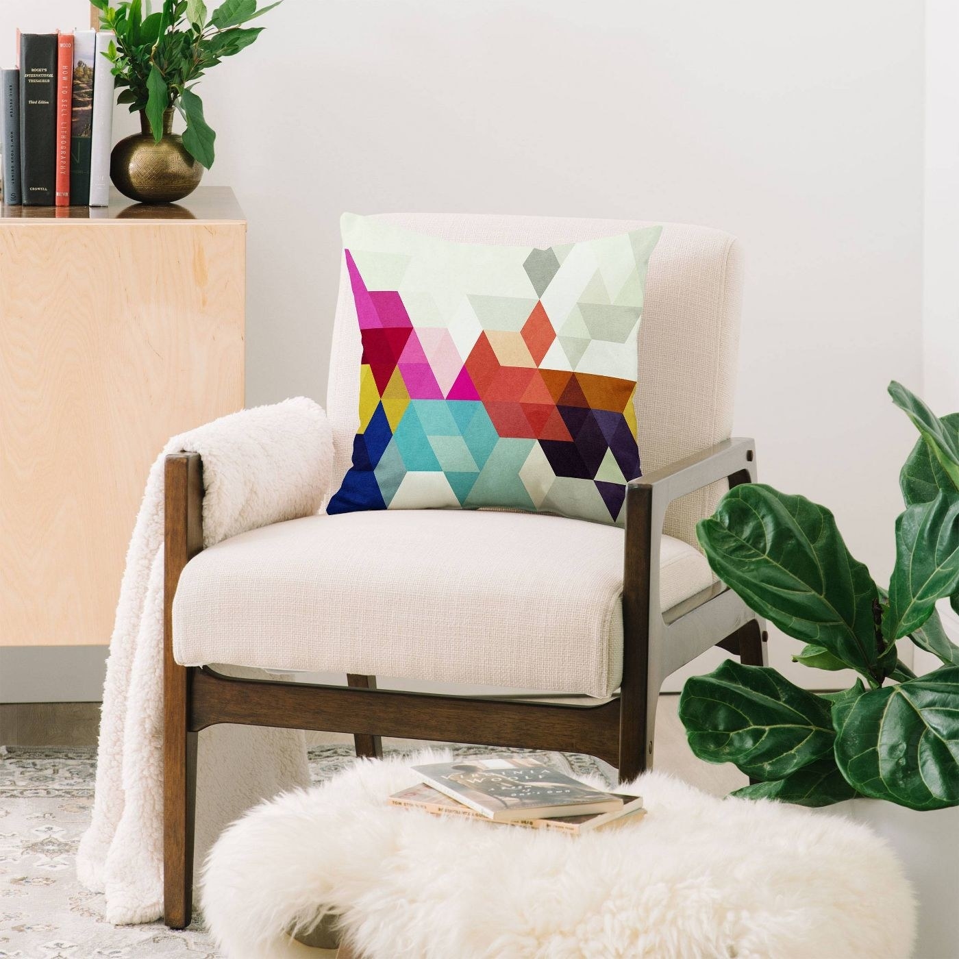 A rainbow pillow in a cream chair