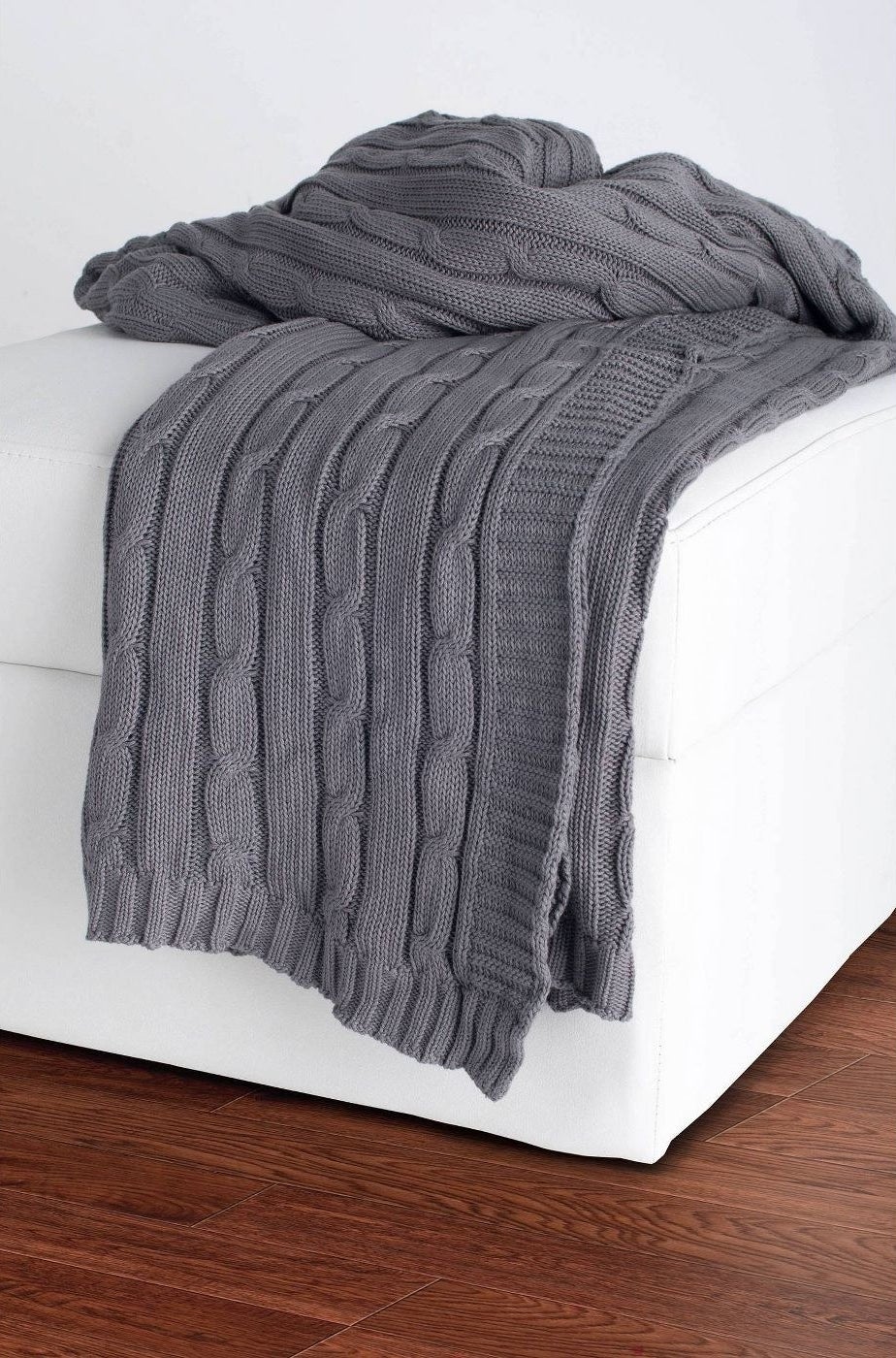 A gray cable knit blanket in a home