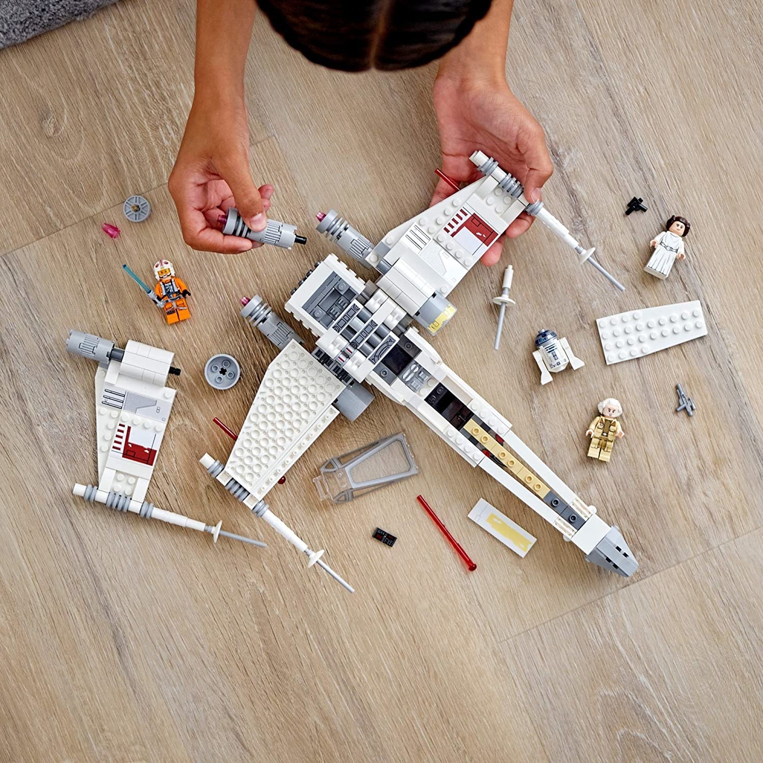 hands putting together the LEGO set