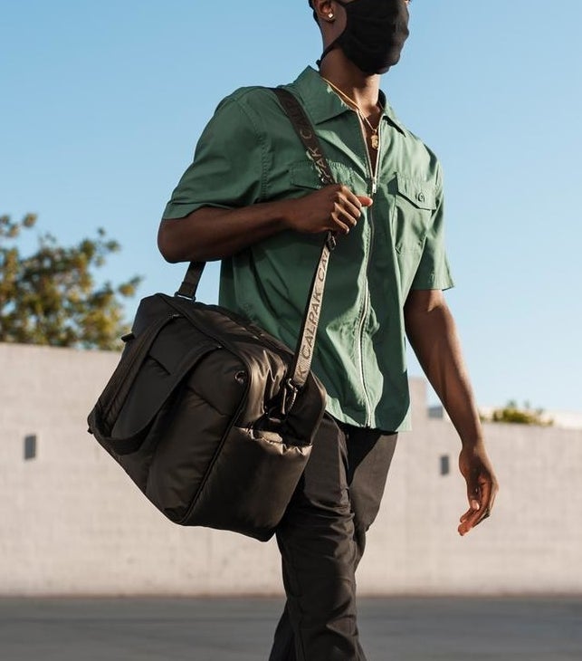 model carrying the bag in matte black